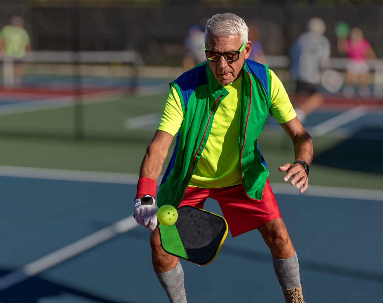 A man practicing his dinking in pickleball