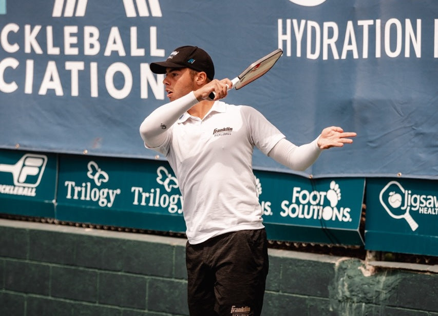 Ben Johns playing singles pickleball at a tournament.