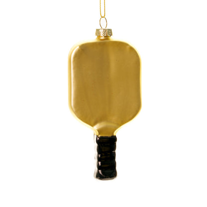 Back side of an elegant handmade glass red and gold pickleball paddle Christmas ornament hanging in front of a white studio backdrop