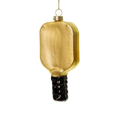 Back side of an elegant handmade glass green and gold pickleball paddle Christmas ornament hanging in front of a white studio backdrop