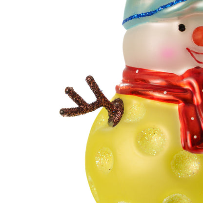 Close up of the arm of a handmade glass Christmas ornament of a pickleball snowman on a white studio backdrop