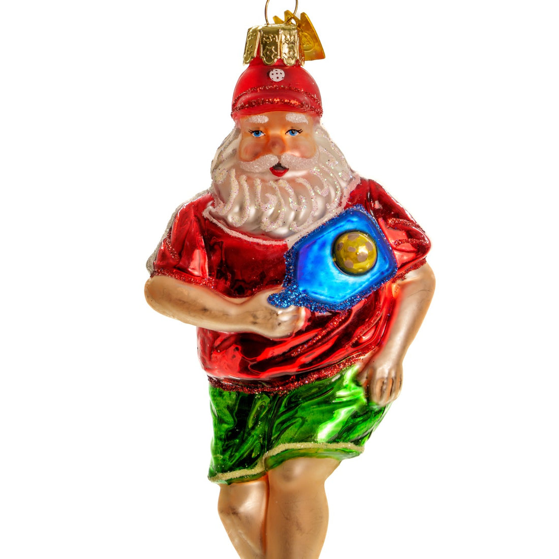 Close up of an elegant handmade glass Christmas ornament of Santa playing pickleball  hanging in front of a white studio backdrop