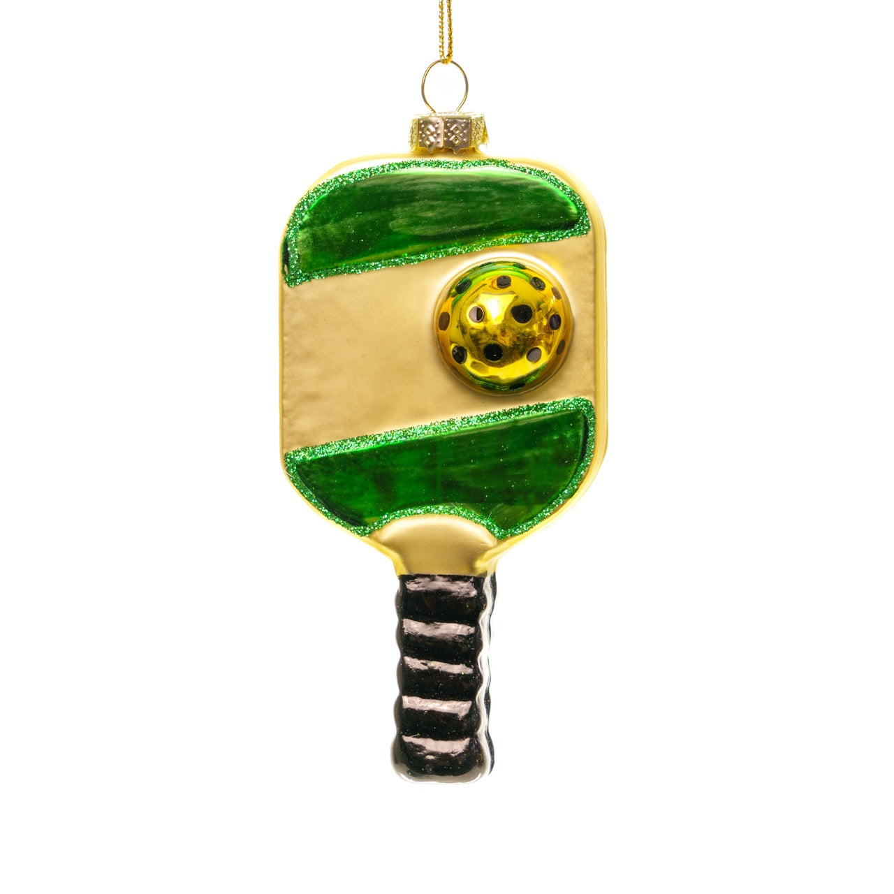 Front of a handmade glass green and gold pickleball paddle Christmas ornament hanging in front of a white studio backdrop