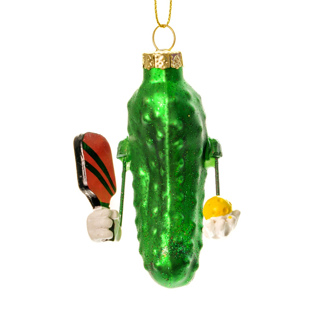 Fun handmade Kurt Adler Christmas ornament of a pickle holding a pickleball paddle and a pickleball on a white studio backdrop