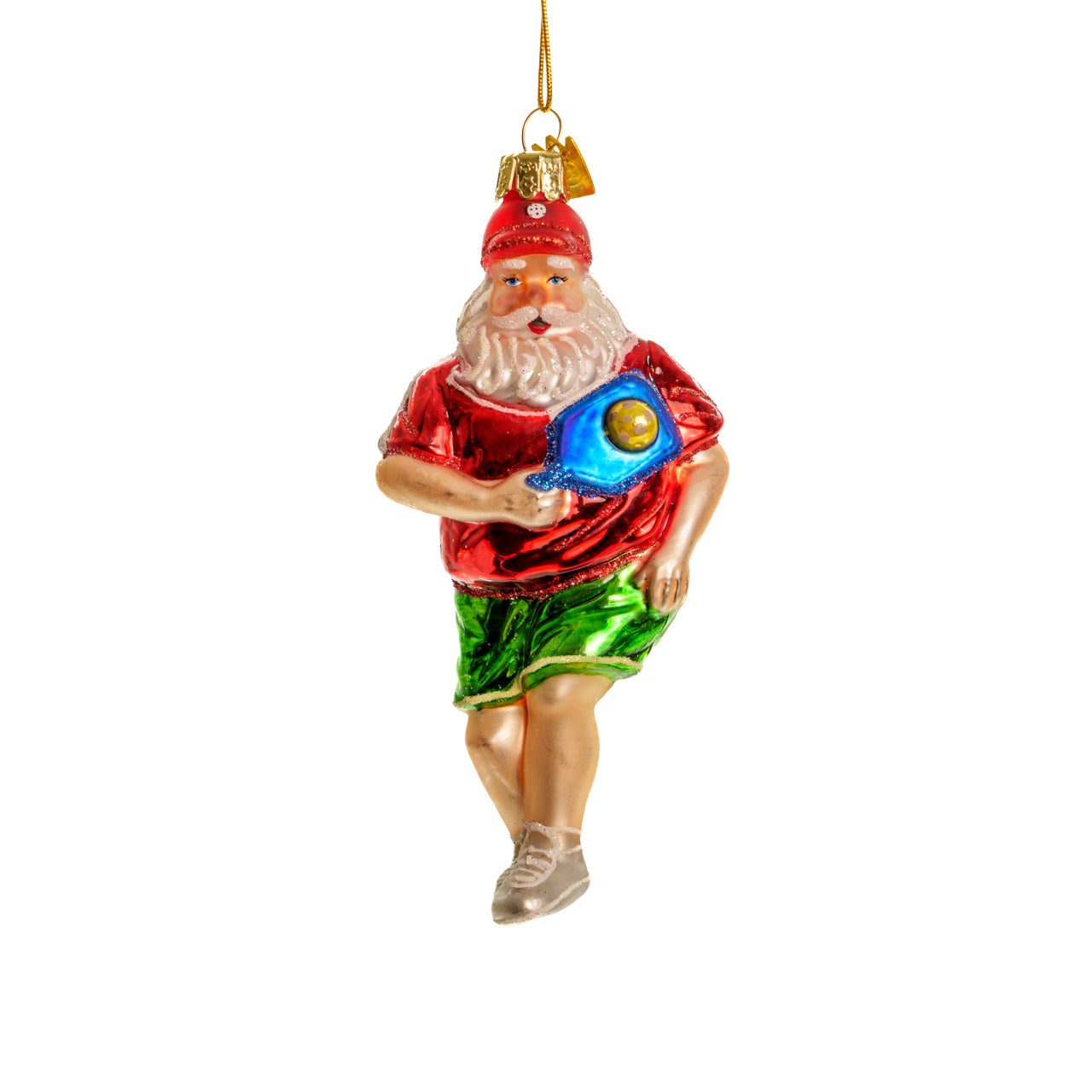 Elegant handmade glass Christmas ornament of Santa playing pickleball  hanging in front of a white studio backdrop