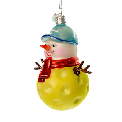 Left side of a handmade glass Christmas ornament of a pickleball snowman on a white studio backdrop