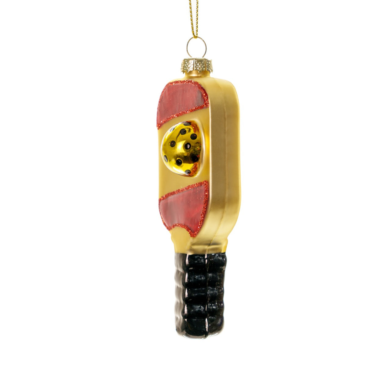 Left side of an elegant handmade glass red and gold pickleball paddle Christmas ornament hanging in front of a white studio backdrop