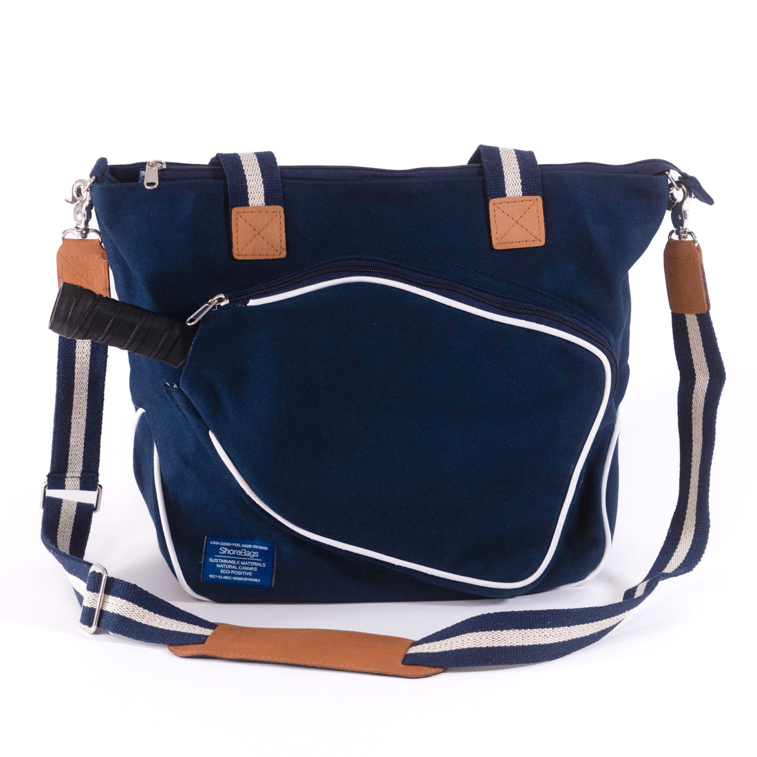 Blue canvas pickleball bag with white accents and a leather strap