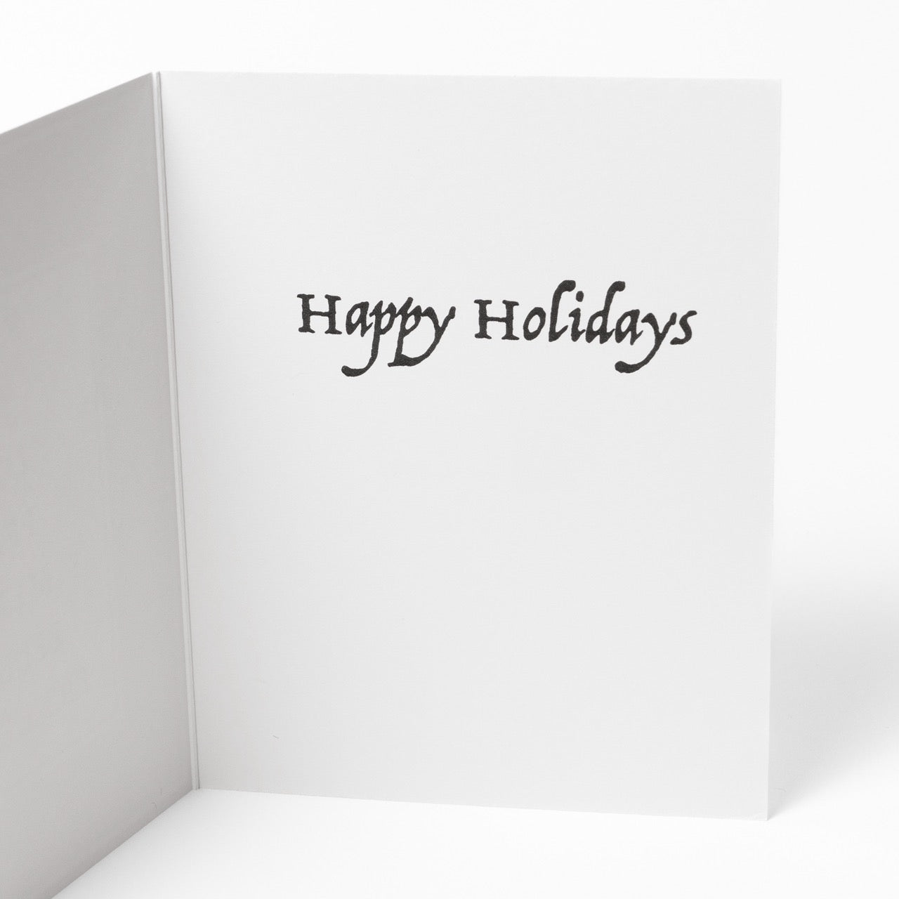 Close up of the inside message of a pickleball themed greeting card with festive words stacked like a Christmas tree with a message that says &quot;Happy Holidays&quot;