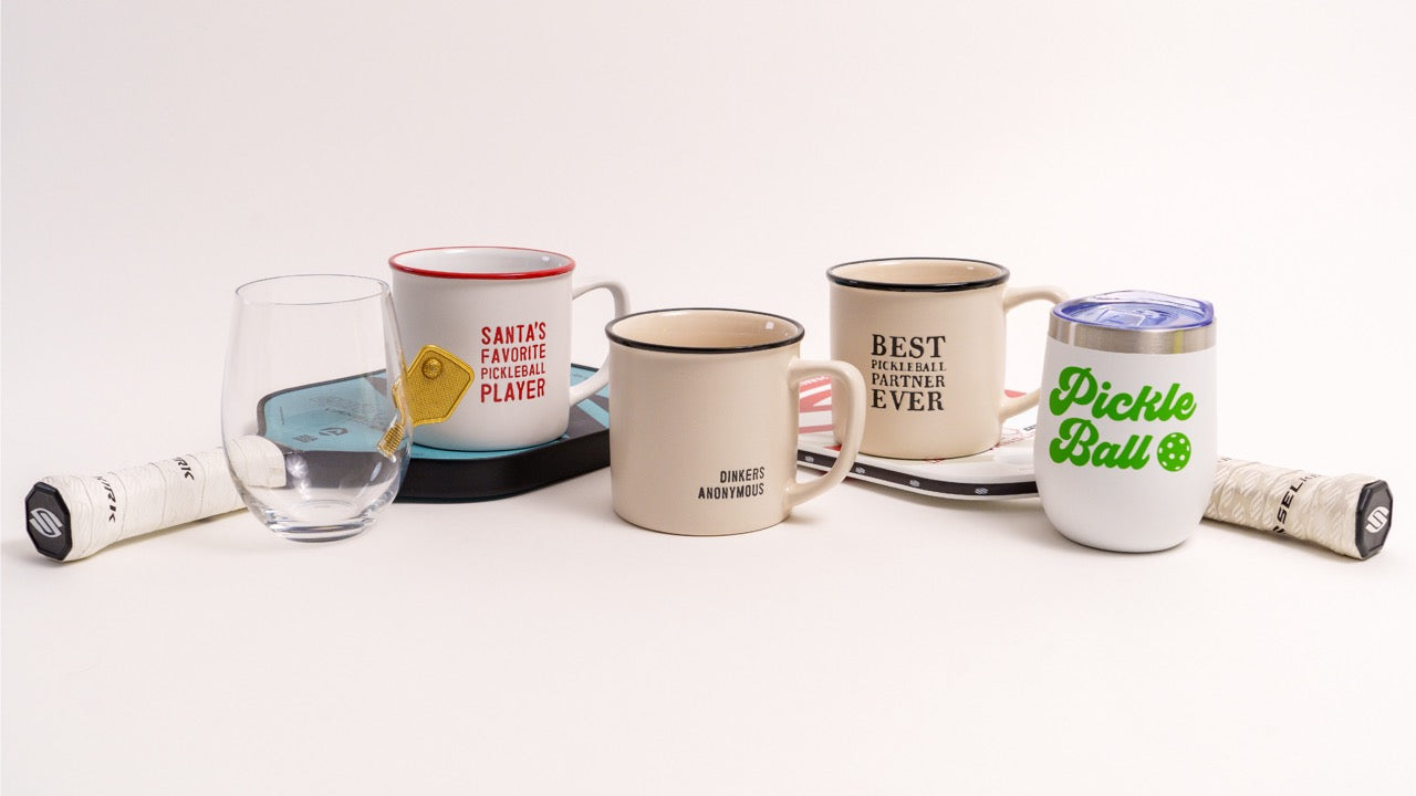 Collection of pickleball themed drinkware on pickleball paddles