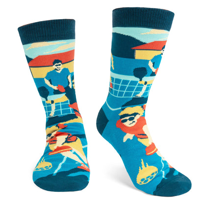 Humorous blue socks with people playing pickleball on them being worn