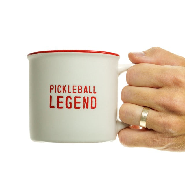 Ceramic mug that says Pickleball Legend on it in red being held by a man