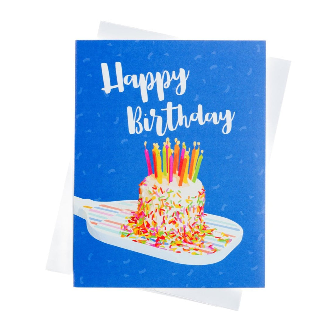 Colorful pickleball themed birthday card with a birthday cake with candles sitting on a pickleball paddle and big bold text that reads Happy Birthday laying flat on a white background.