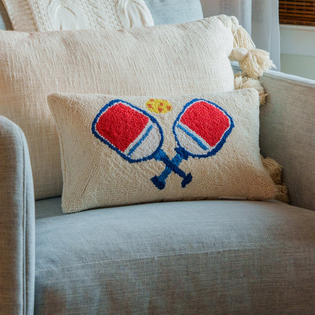 Pickleball Paddle Hook Pillow on a chair