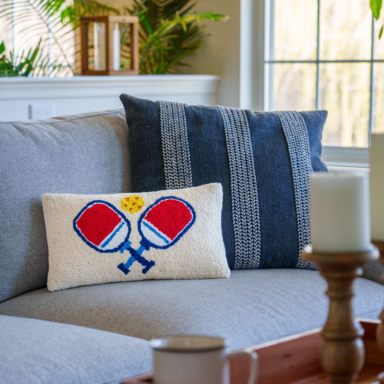 Hook pillow with pickleball paddles on it on a couch