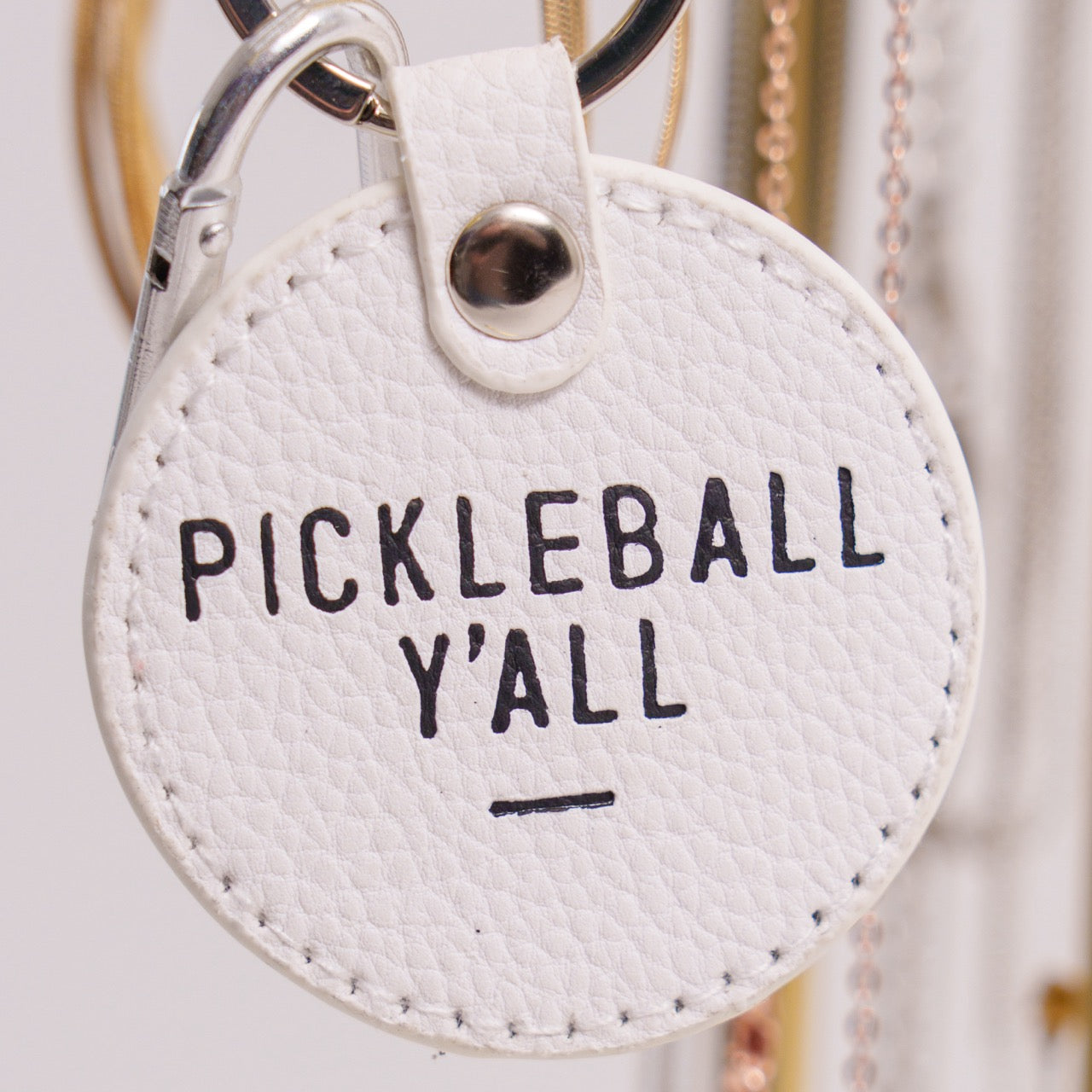 White keychain that says Pickleball Y&