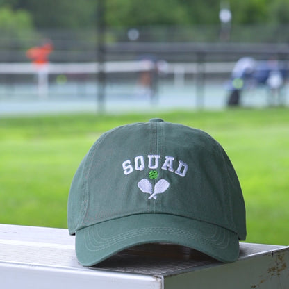 Video of a green baseball hat with a green embroidered pickleball and white words saying SQUAD on it.