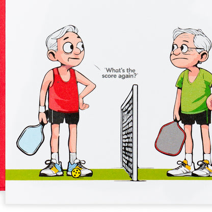 Close up of a funny pickleball birthday card with two cartoon men playing pickleball looking confused