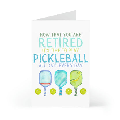 Pickleball-themed retirement card with pickleball paddles and balls on it slightly open