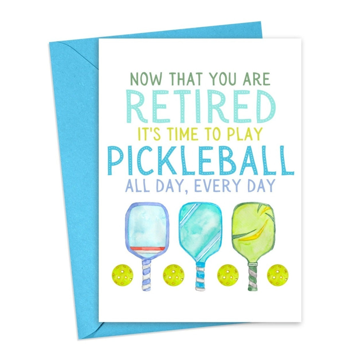 Pickleball-themed retirement card with pickleball paddles and balls on it laying flat