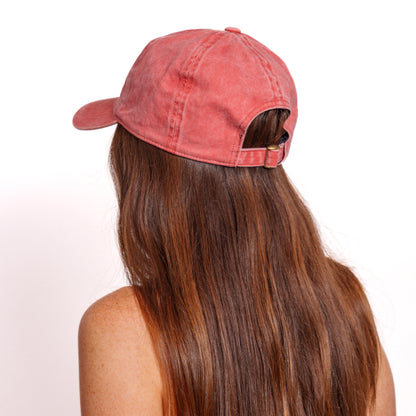 Back view of woman wearing a washed red pickleball themed hat