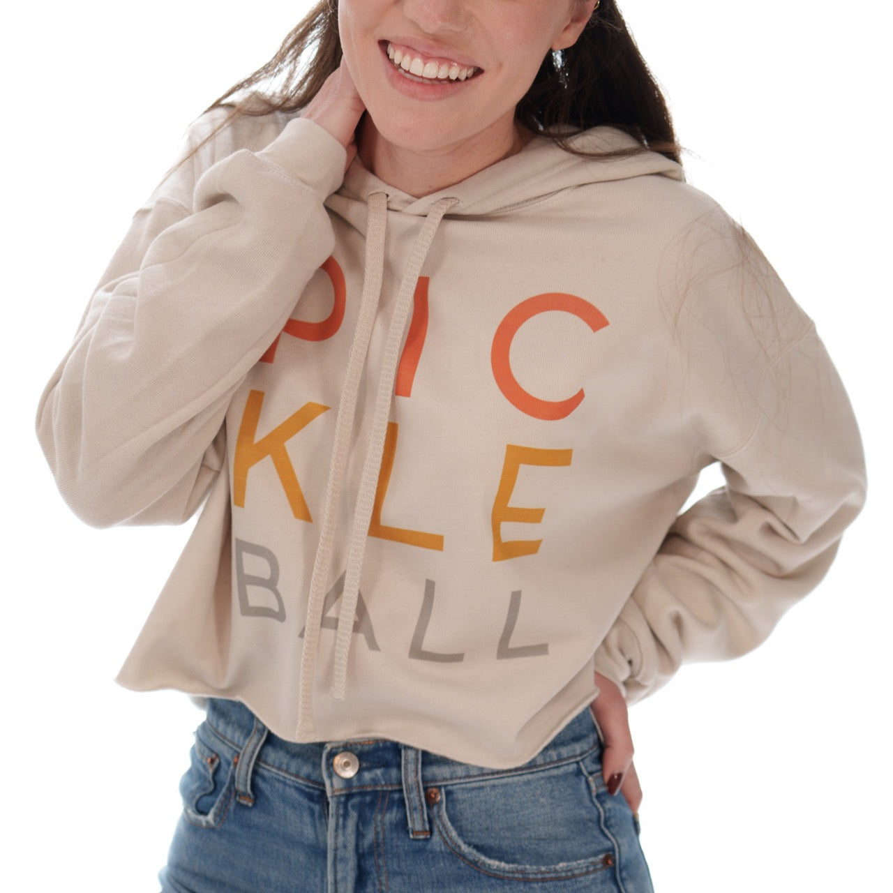 Woman wearing a cropped hoodie sweatshirt that says &quot;PICKLEBALL&quot; on it