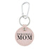 Round pink keychain that says "PICKLEBALL MOM" on it